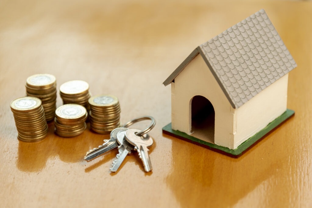 a home with coins and some keys on table